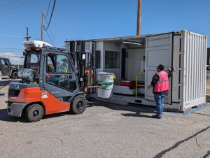 LANL workers place containers on the UDASS 21.05.24